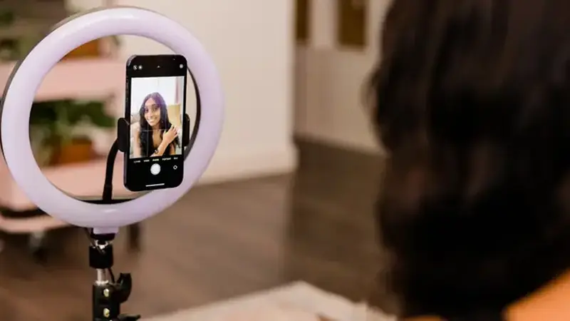 Phone on tripod filming with a ring light