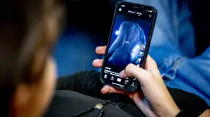 TikTok You For You feed playing on an Android phone held in hand